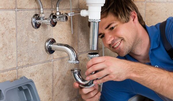 heat for homes services heat for homes plumber in action under sink
